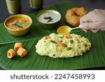 Small photo of Ven Pongal Khara Pongal with Sambar and coconut chutney. Woman hand serving Indian breakfast food. Tamil Nadu Pongal Sankranti Diwali festival food. Rice lentil semolina rava South India Sri Lanka