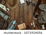 Hiking gear frame including backpack machete, knife, clothes, boots, lantern, camera, hat, map, compass. Packing for a hike concept. Wanderlust, safari equipment postcard, poster, banner background.