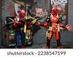 Small photo of Bangkok, Thailand - December 12,2021: A setting of Deadpool and Spiderman action figures on diorama setting.