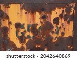 Small photo of Funky metal panel with chipped yellow paint, rusty patches and obliterated stenciled numbers abstract industrial background