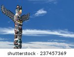 isolated totem wood pole in the blue cloudy background