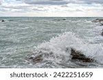 Small photo of sea in tempest on rocks with splashes