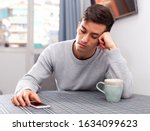 Man is chatting on phone and upset alone at home