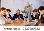 Small photo of Elderly female boss expresses dissatisfaction with the work of the top managers team