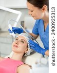 Small photo of Beautiful female doctor making facial gas-liquid oxygen water epidermal peeling using professional equipment use macromolecule atomizing pen for young girl at modern spa salon. Skin care concept