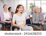Small photo of small group of women are sitting in audience and listening to lecture. students of course laugh heartily at joke of teacher