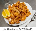 Small photo of Fried Andalusian baby squid in a batter of tempera flour, served with lemon
