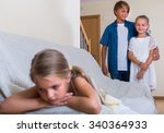 Small photo of Upset little girl is jealous sister of stepbrother indoors. Focus on kids couple
