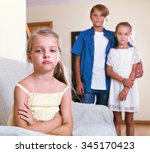 Small photo of Upset offended girl is jealous sister of stepbrother indoors