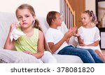 Small photo of Little upset girl is jealous sister of stepbrother indoors