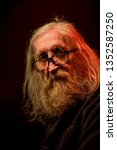 Small photo of Brno, Czech republic - 03, 09 2019: Portrait of Vratislav Brabenec during concert of band The Plastic People of the Universe, with subheading of concert: Vzpominka na Mejlu.