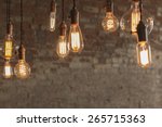 Decorative antique edison style light bulbs against brick wall background