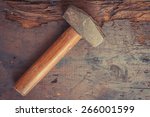 Small photo of Small single handed worn sledge hammer on grunge wood background