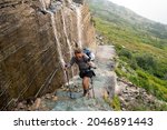 Brave Woman Hiker Climbs Up A...