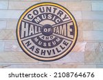 Small photo of Nashville, Tennessee - January 10, 2022: Logo and sign for Country Music Hall of Fame and Museum - where it shows the evolving history and traditions of country music from yesterday and today