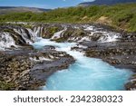 Bruarfoss waterfall on a sunny day in summer. Features beautiful teal turquoise water in Iceland along the Golden Circle area