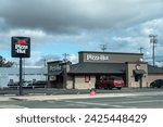 Small photo of Coolidge, Arizona - December 23, 2023: Pizza Hut chain restaurant, exterior view and sign