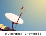 satellite dish and TV antennas on the house roof with blue sky background