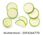 Pieces of sliced zucchini isolated over white background. Flat lay, top view