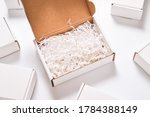 White paper filler in cardboard box, set of white carton boxes