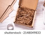 Brown cardboard box on white wooden background 