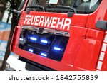 German fire engine in action with alarm light / Feuerwehr means Fire Department