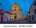 Small photo of Vilnius, Lithuania, July 6, 2022: Night view of a street leading towards The Church of St Theresa in Vilnius, Lithuania..