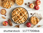 Homemade Apple Pies on white wooden background, top view. Classic autumn Thanksgiving dessert - organic apple pie.
