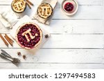Pi Day Cherry and Apple Pies - homemade traditional various Pies with Pi sign for March 14th holiday, on white wooden background, top view, copy space.