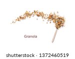 Nut Granola on spoon isolated on white background, copy space. Healthy snack or breakfast concept - homemade granola with grains and nuts.