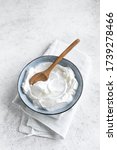 Small photo of Homemade Yogurt in bowl on white table. Organic plain greek yogurt for healthy breakfast recipes.