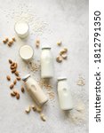 Small photo of Vegan plant based milk and ingredients, top view, copy space. Various dairy free, lactose free nut and grains milk, substitute drink, healthy eating.