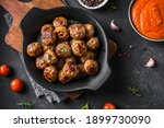 Fryed meatballs on black background, top view, copy space. Beef roasted meatballs ready for eat.