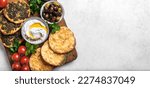 Small photo of Arabic breakfast, labneh yogurt, manakeesh or pita bread with cheese and zaatar, olives and vegetables, top view, banner. Middle eastern meal, arabic cuisine.