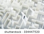 Business challenge. A businessman navigating through a maze. Top view
