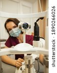 Small photo of Optometrist slit lamp, ophtalmology diopters calibration in oculist lab of young woman doctor.