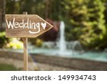 Wedding decor. Wooden plaque with the inscription Wedding. Wedding on a plate green background and a fountain. Wedding decorations,
