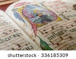 Small photo of Genova, Italy - July 2015 - Medieval ancient illustrated illuminated monastic manuscript with sheet music Gregorian chant, illustrative editorial, artistic selective focus