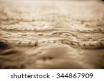 Small photo of Artistic abstract background. A detail of an old medieval book parchment with gregorian chant sheet music notes artistic sepia vintage edit with a strong vignette and selective abstract focus