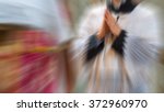 Small photo of Artistic abstract radial blur edit of an altar boy or a mass server kneeling in surplice during the traditional tridentine latin catholic mass with his hands joined in prayer