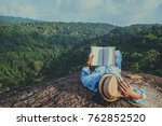 Asian man travel relax in the holiday. sleep relax read books on rocky cliffs. On the Moutain. In Thailand