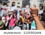 A raised fist of a protestor at ...