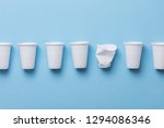 Single use white plastic cups on a blue background