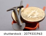 Small photo of BItcoin crypto currency mining. Bitcoin gold coin with a mining pickaxe