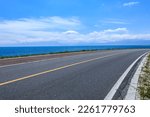 Small photo of Asphalt road and lake with sky clouds natural scenery in Xinjiang, China.