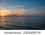 Lake Erie with shoreline at sunset. It is the fourth largest lake of the five Great Lakes in North America. At its deepest point it is 210 feet deep.
