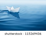 Paper Boat Sailing On Blue...