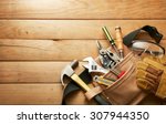 Tools in tool belt on wood...