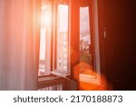 Old wood small window illuminate with bright sunlight in evening or morning time