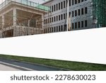Small photo of Blank hoarding with copyspace for advertising mockup on construction site with unfinished building outdoor